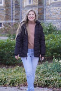 Bianca standing in front of a stone building